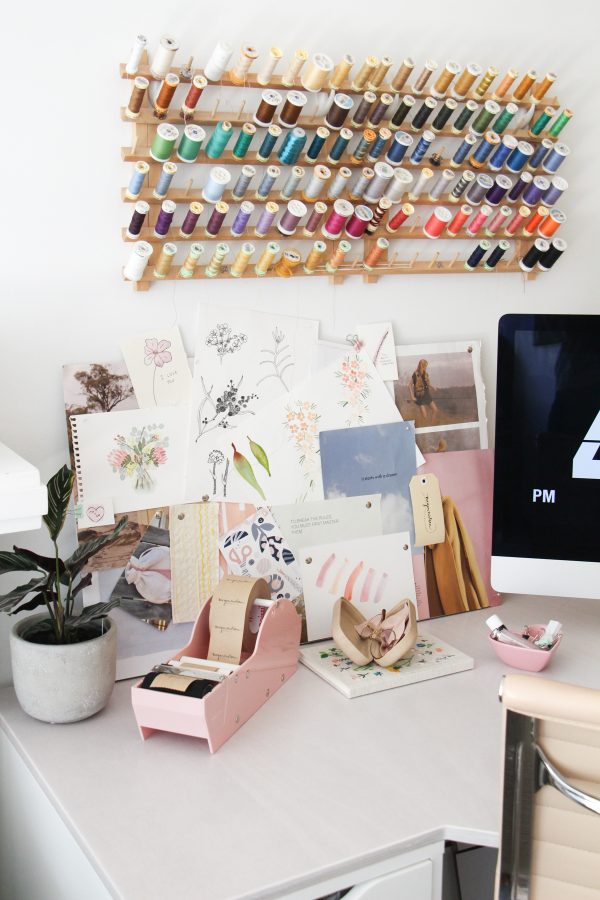 Wall mounted spool rack and inspiration board in Megan Nielsen's workroom