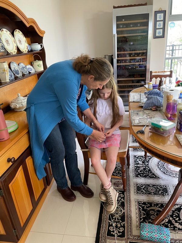 Birdie practicing knitting with Ouma