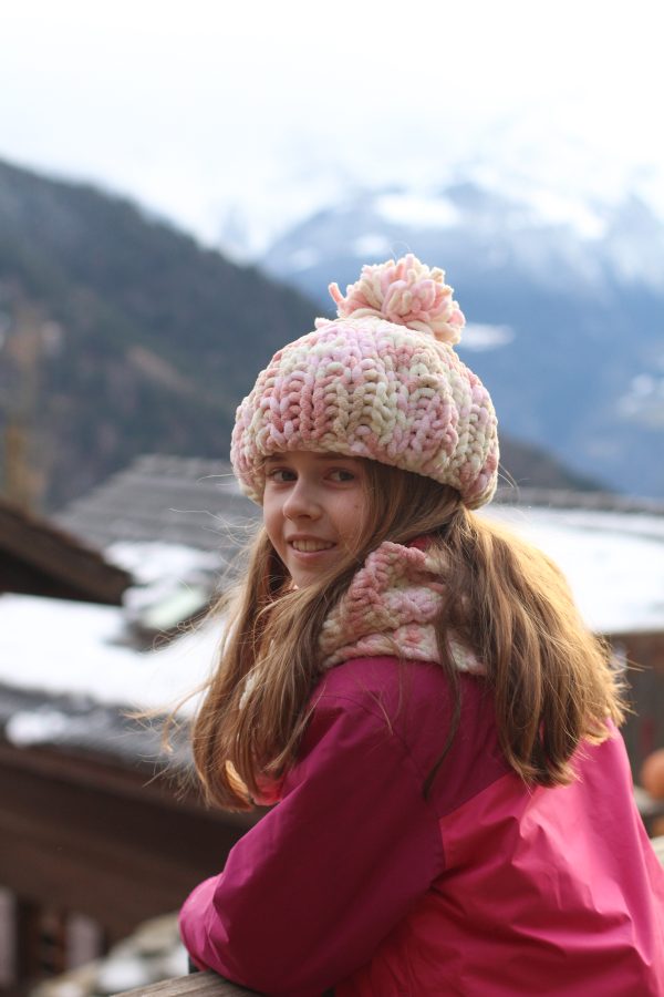 Birdie wearing handmade hat and scarf in Switzerland